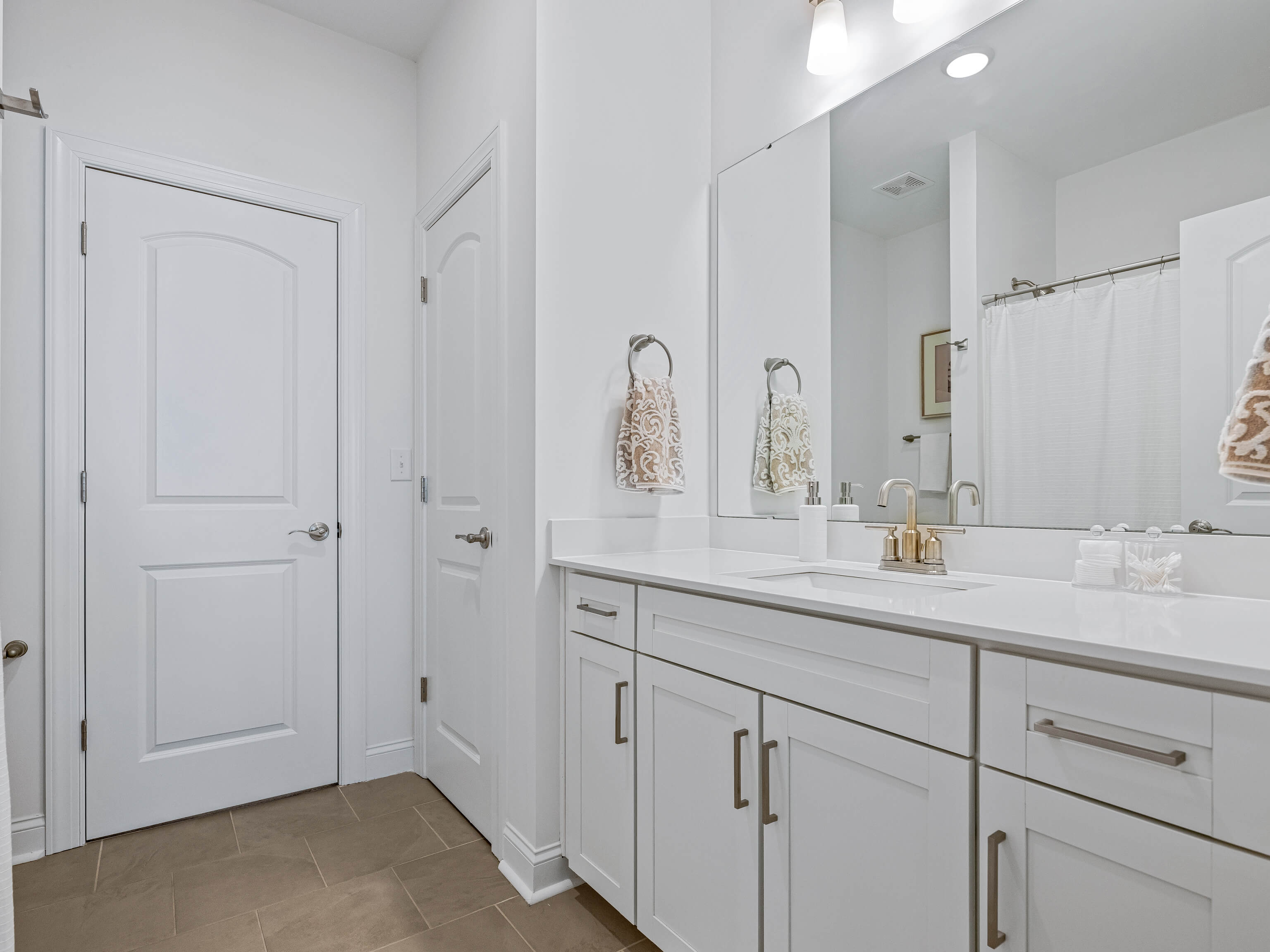 Hall bathroom with white vanity