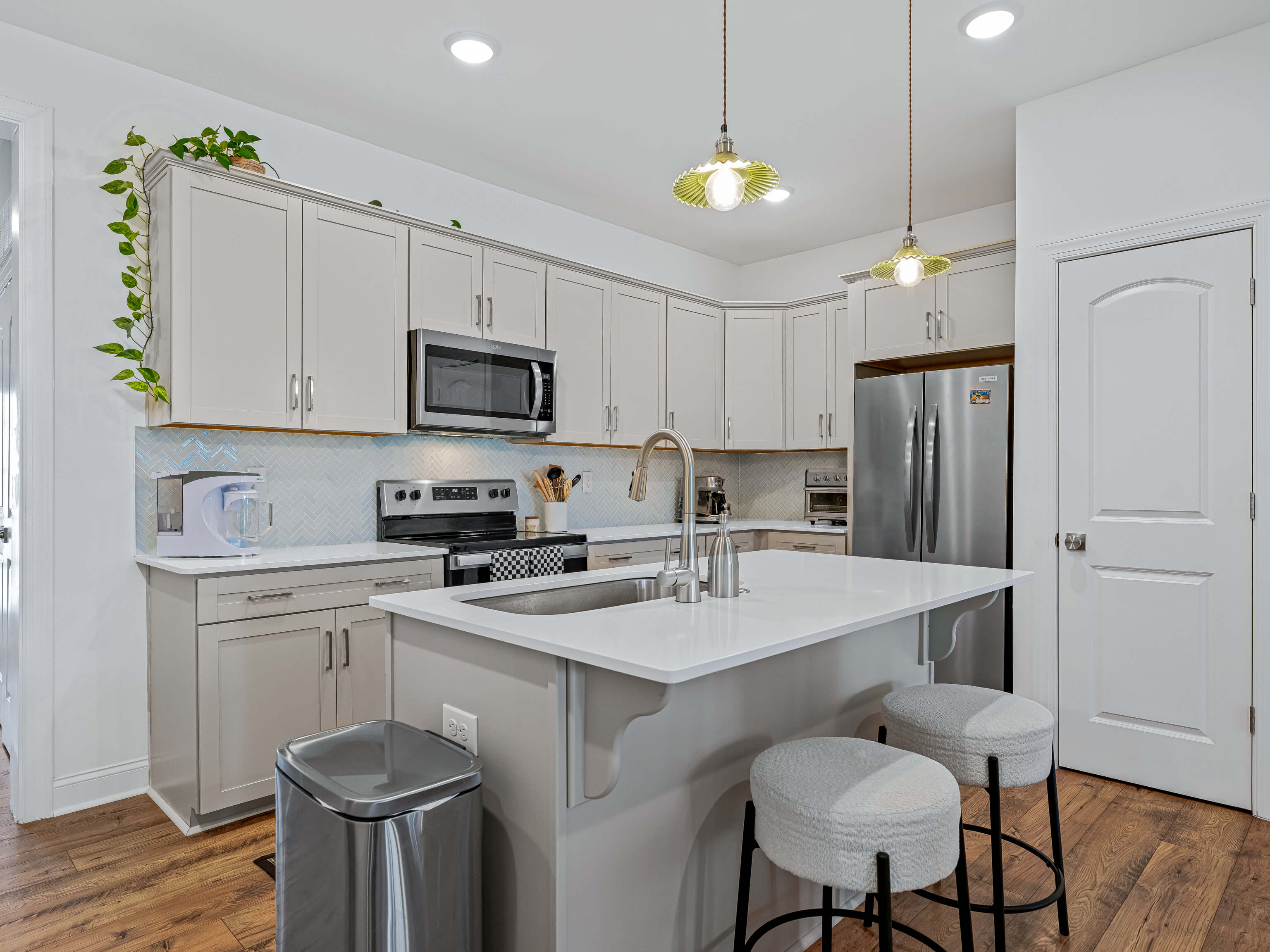 Kitchen island with breakfast bar seating and modern bar stools